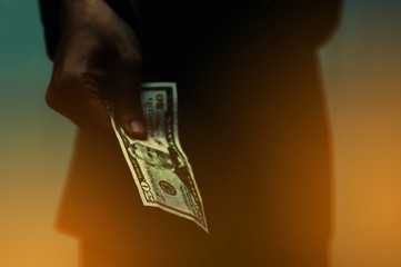 A man hand holding one Fifty dollar US to give money