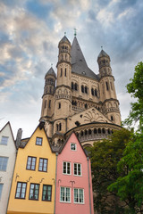 Fototapeta na wymiar Great St. Martin Church and colorful houses in Bavarian style of Cologne. Cologne, North Rhine-Westphalia, Germany.