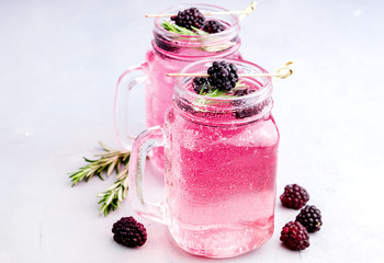 Tasty cold blackberry lemonade with rosemary
