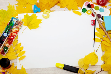 Watercolor paint, brush for painting and autumn leaves