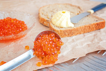 Red caviar on a metal table. Selective focus