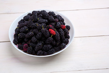 mulberry in white plate, top view