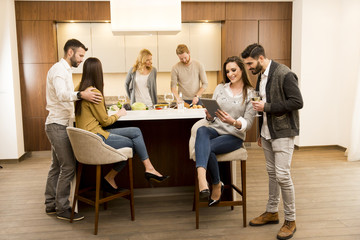 Group of young friends in modern kitchen
