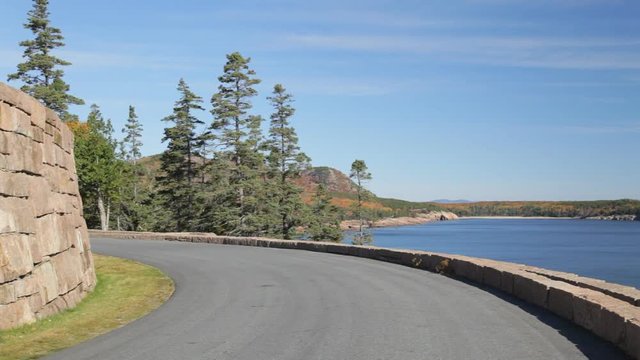 Pan of Ocean Drive (aka Park Loop Road and Acadia All American Road) with Great Head and the Atlantic Ocean in the background. Acadia National Park in Autumn.