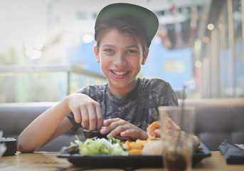 Child eating in a restaurant happily 