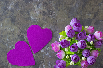 A two decorative purple hearts and flowers on gray  background