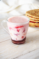 glass of smoothies and pancakes with jam