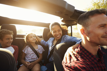 Happy family on a road trip in car, front passenger POV © Monkey Business