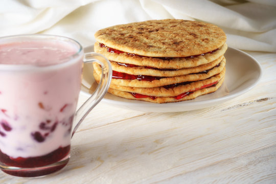 pancakes with jam and glass of smoothies