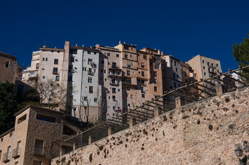 View to hanging houses of Cuenca old town.  Example of a medieval city, built on the steep sides of a mountain. Many houses are built right up to the cliff edge. Cuenca, Spain