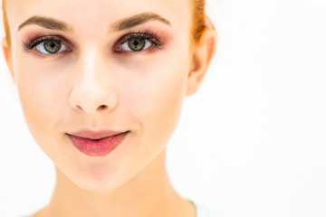 Obraz premium Woman with natural make-up eyes and lips on a light background. Close-up