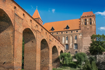 Fototapeta na wymiar Kwidzyn, Poland - August 10, 2014: 14th century brick gothic castle of the Teutonic Order. Horizontal image in a sunny day..