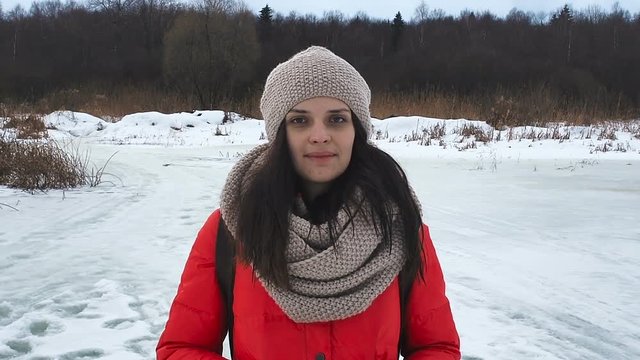 Charming winter lady in hat looks right into the camera
