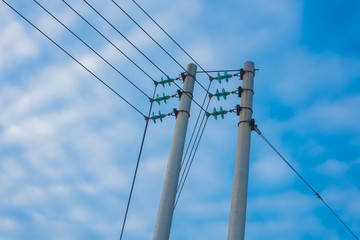 high voltage power towers lines on a background of blue sky
