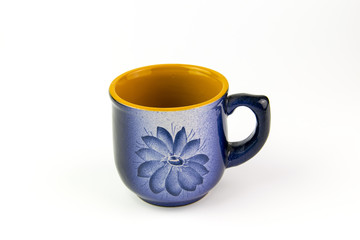 Beautiful blue cup with a pattern on a white background.