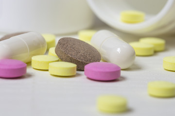 Colored pills on a white surface