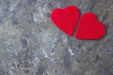 A two decorative red hearts on a gray background