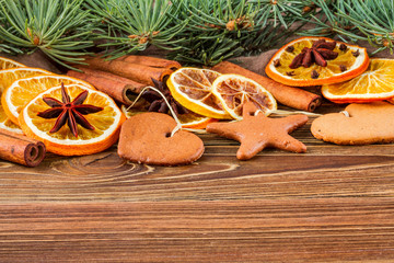 Dried oranges, star anise, cinnamon sticks and gingerbread on a wooden background -- Christmas still life background