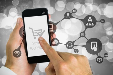 Composite image of hand holding smartphone