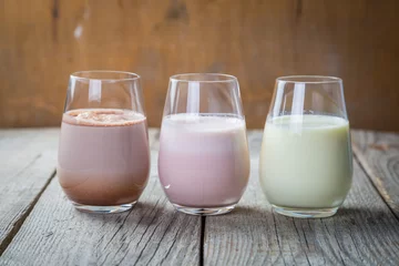 Foto op Plexiglas Milkshake Selection of flavoured milk - strawberry, chocolate, banana