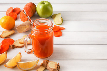 Natural detox carrot smoothie ingredients on white background