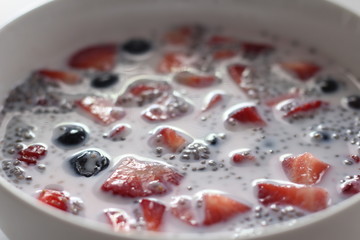 Chia pudding with fresh strawberries and blueberries in bowl