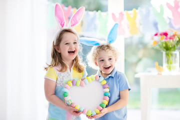 Obraz na płótnie Canvas Kids in bunny ears on Easter egg hunt