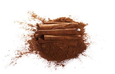 cinnamon sticks and pile cocoa powder isolated on white background
