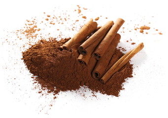 cinnamon sticks and pile cocoa powder isolated on white background