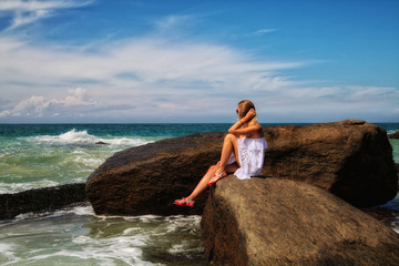 girl in a beautiful dress walks on the beach