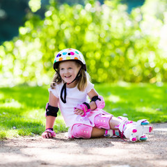 Little girl with roller skate shoes in a park