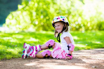Little girl with roller skate shoes in a park