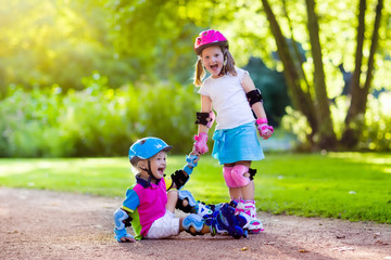 Kids roller skating in summer park