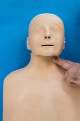 Paramedic practicing resuscitation on dummy