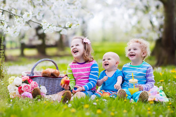 Kids having picnic in blooming garden