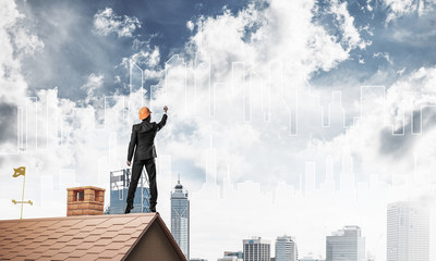 Man architect draw silhouette of modern city on blue sky. Mixed 