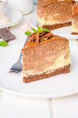 Marble chocolate coffee cheesecake with meringue, marshmallow and chocolate on top