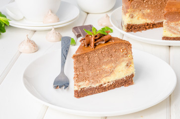 Marble chocolate coffee cheesecake with meringue, marshmallow and chocolate on top