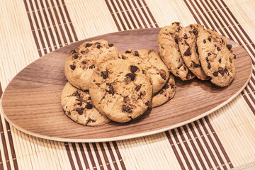 Cookies with chocolate chips on the oval wooden tray, diagonal