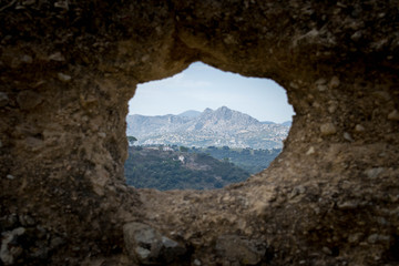 mountains through a hole in the wall