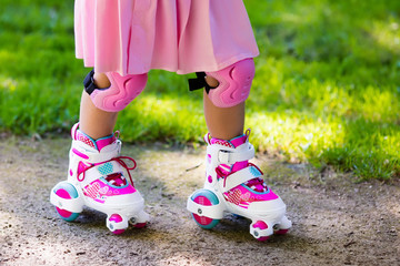 Little girl with roller skate shoes in a park