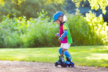 Kids roller skating in summer park