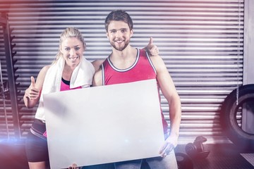 Fit couple holding blank paper