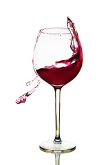 Red wine splashing in glass on a white background