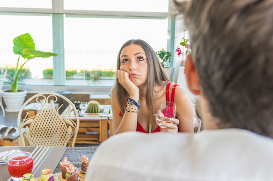 Woman making an exasperated expression gesture on a bad date 