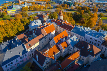 Nice red roofed medieval houses and towers of old Tallinn. Aerial view, autumn season.