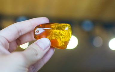Hand holding amber stone