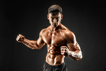 bodybuilder posing. Beautiful sporty guy male power. Fitness muscled man