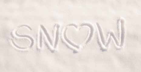 Word snow with a heart, written in pure, fresh snow - concept of loving snowy weather
