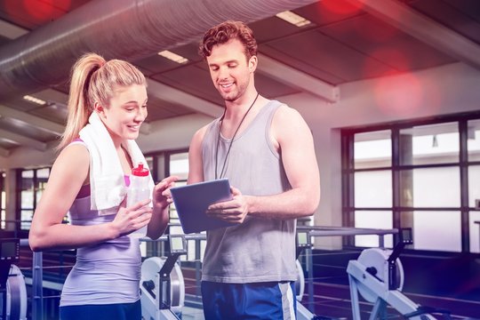 Woman talking to trainer after workout